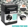 A black electronic piggy bank with a silver dispenser and keypad is shown next to US currency.