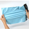 Hands holding a light blue heavy-duty waterproof poly mailer bag for shipping and storage