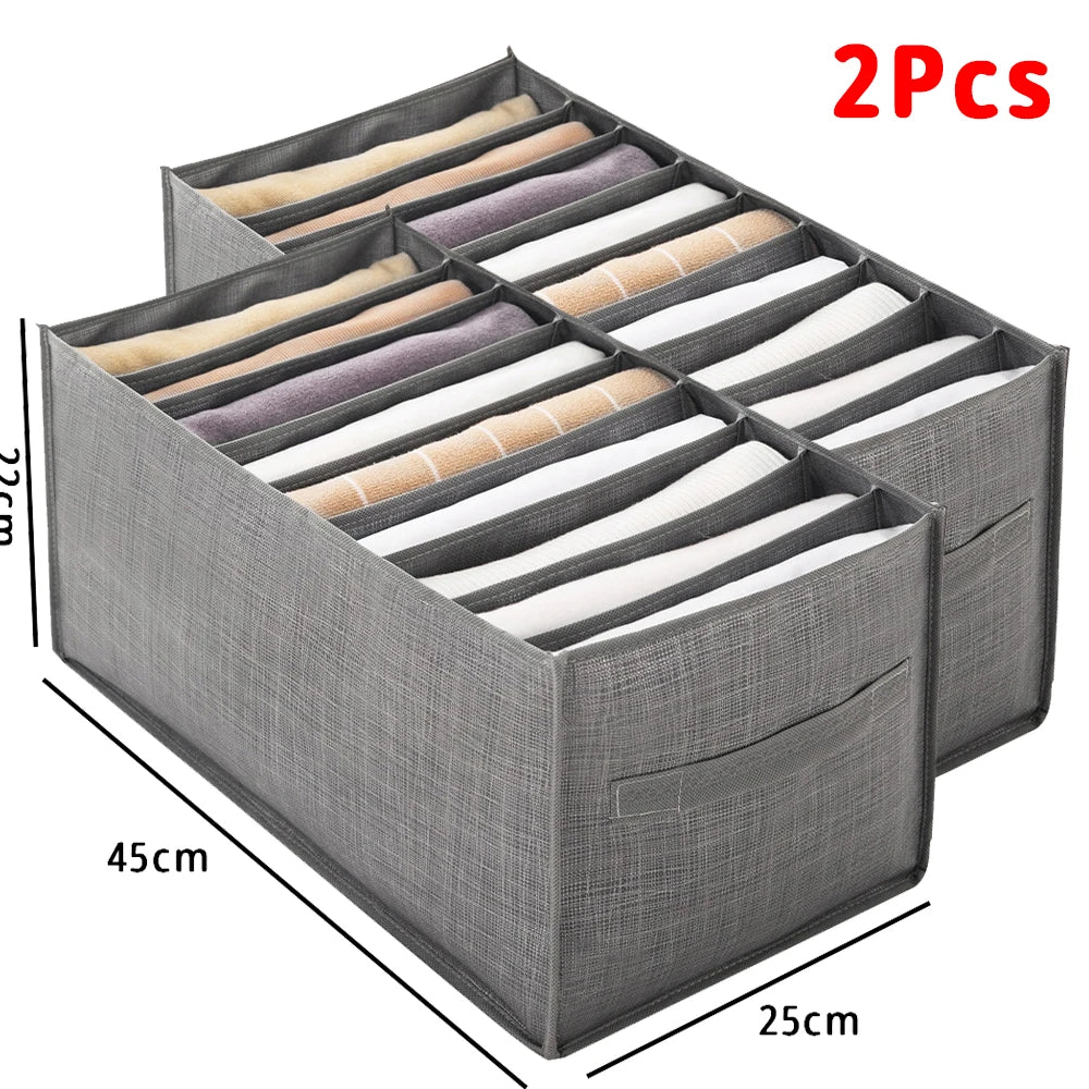 A gray foldable fabric closet organizer with handles showing two pairs of folded fabric items.