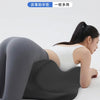 A woman is lying down, using a black ergonomic memory foam pad for sexual fertility management.