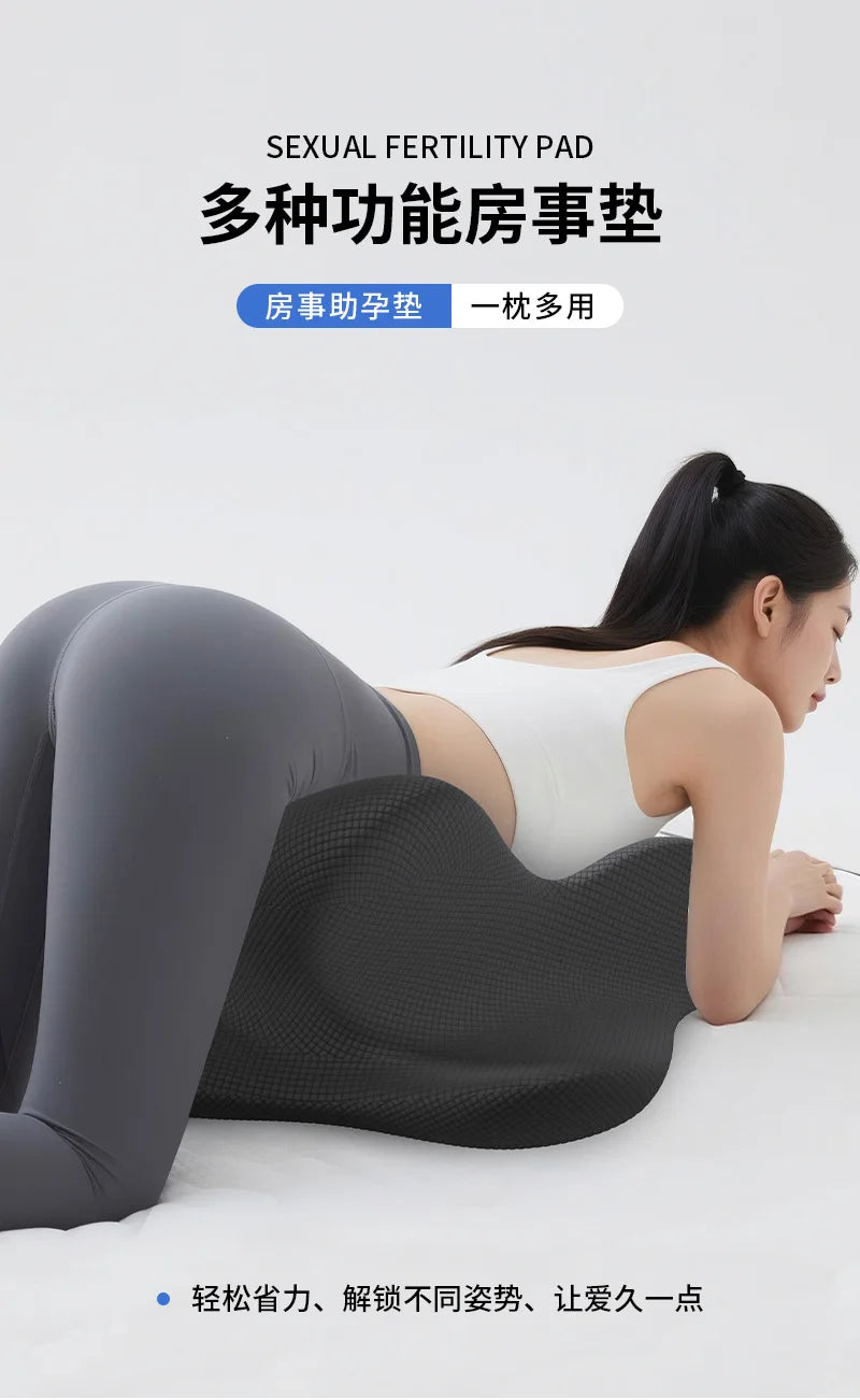 A woman is lying down, using a black ergonomic memory foam pad for sexual fertility management.