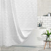 White boho waterproof shower curtain with diamond pattern and tassels hanging over a modern bathtub.