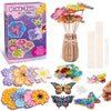 A box of Poke-Fun Flower Dress craft kit showing various fabric flowers and a hand holding a finished flower.