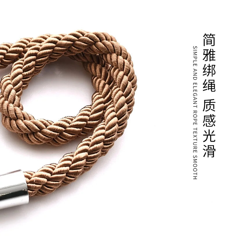 A close-up view of a natural beige rope tieback with a silver metal clasp.