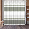 A shower curtain featuring a vertical geometric stripe pattern in shades of sage green and white.
