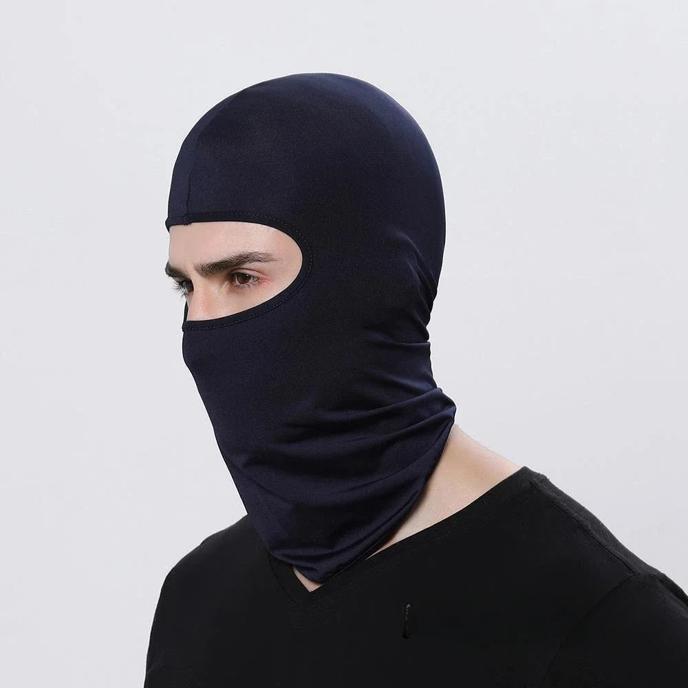 A person wearing a dark navy blue windproof full face balaclava.