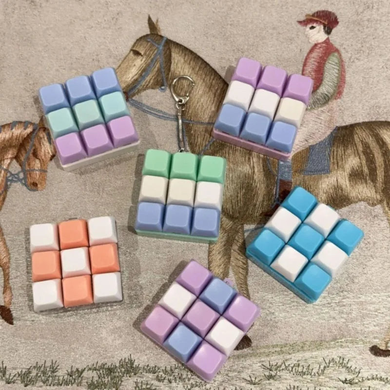A collection of colorful tactile clicking keyboard fidget toys shaped like blocks, displayed next to a horse and a figure.