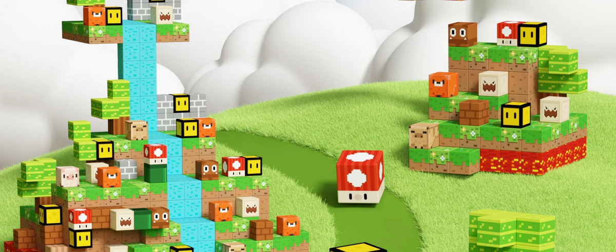 A collection of colorful magnetic building blocks and structures built on a green landscape.
