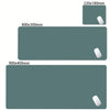 A set of oversized non-slip desk mats in a muted teal color, shown in various rectangular sizes.