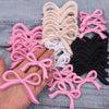 Assortment of pink and white curly ribbon bows for DIY clothing decoration