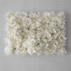 A dense wall panel of white silk rose flowers for weddings and events.