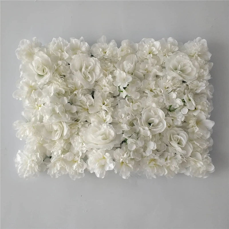 A dense wall panel of white silk rose flowers for weddings and events.