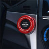 Close-up of a red rotating cover for a car ignition start button labeled Start/Stop Engine.