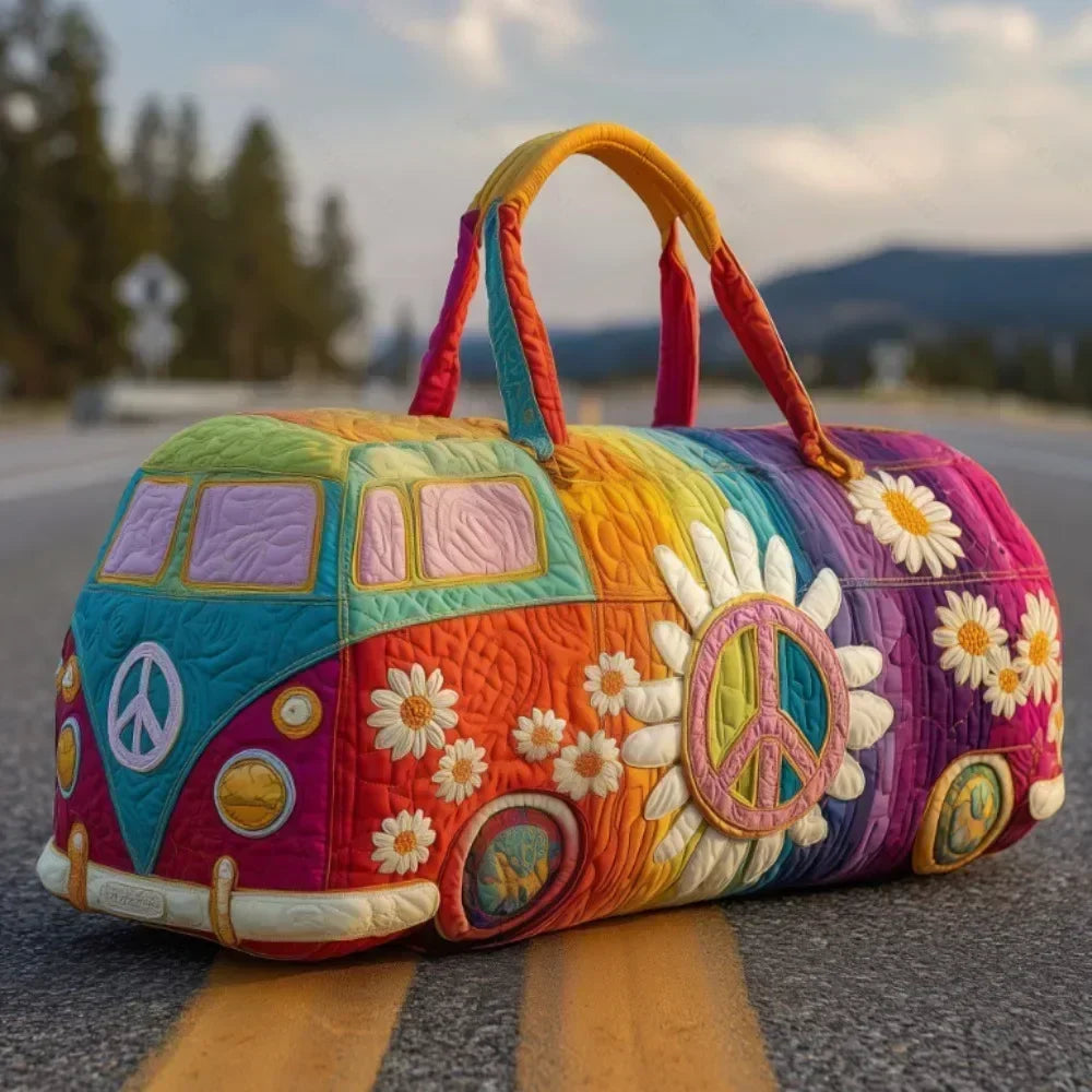 A colorful quilted travel duffle bag with a green and purple design rests on an asphalt road.