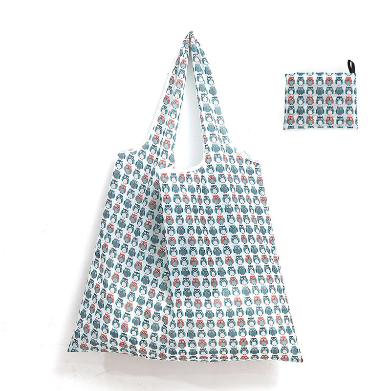 A white and blue patterned reusable shopping tote bag with an attached small carry pouch.