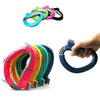 A hand is holding a colorful ergonomic grocery bag carrier with soft-grip handles.