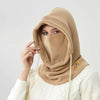 A woman wearing a beige 3-in-1 winter balaclava with a hood covering her face and neck.