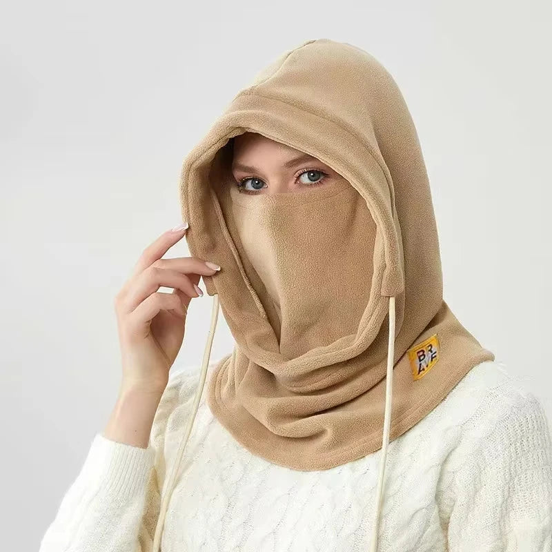 A woman wearing a beige 3-in-1 winter balaclava with a hood covering her face and neck.