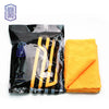 A black package of yellow reusable microfiber cleaning cloths next to a bright orange towel.