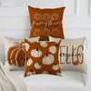 A set of orange pumpkin-themed pillow covers featuring carved pumpkins and fall text on a white sofa.