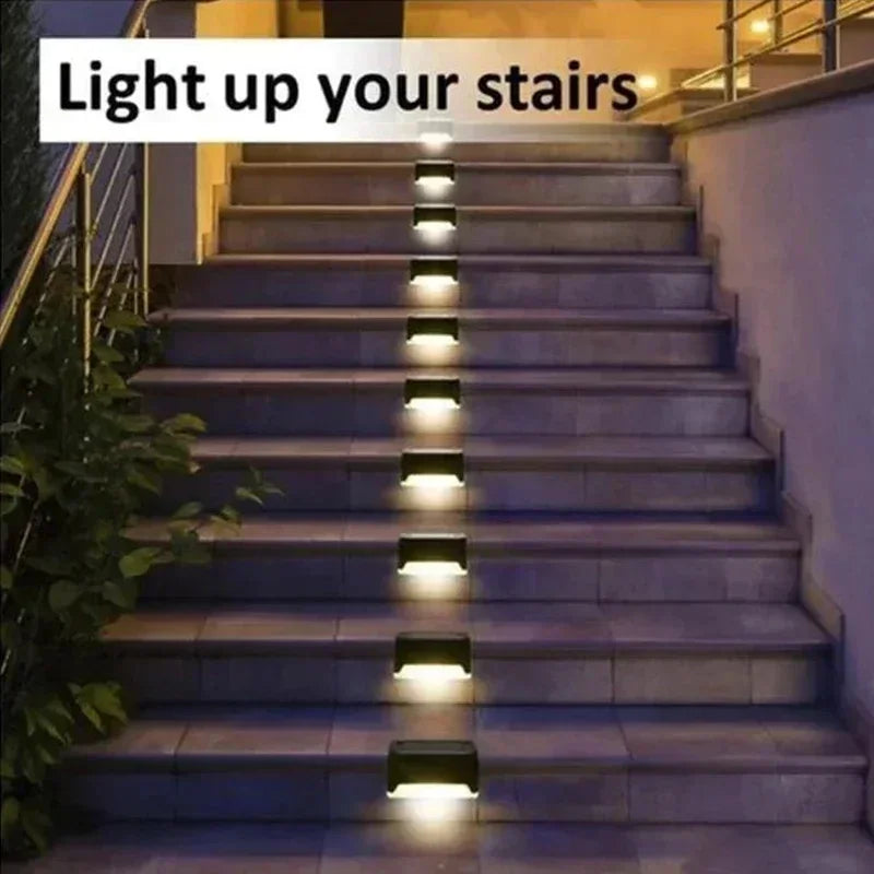 A set of solar powered LED step lights illuminating a set of outdoor stairs.