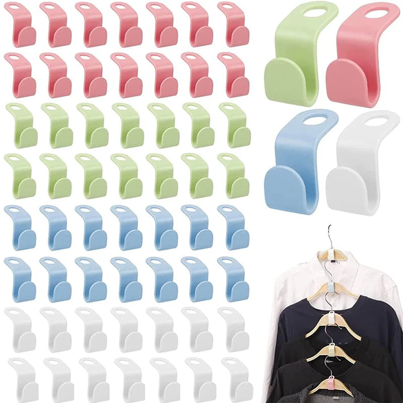 A collection of pink, green, and light blue space-saving cascading hanger connectors for closet organization.