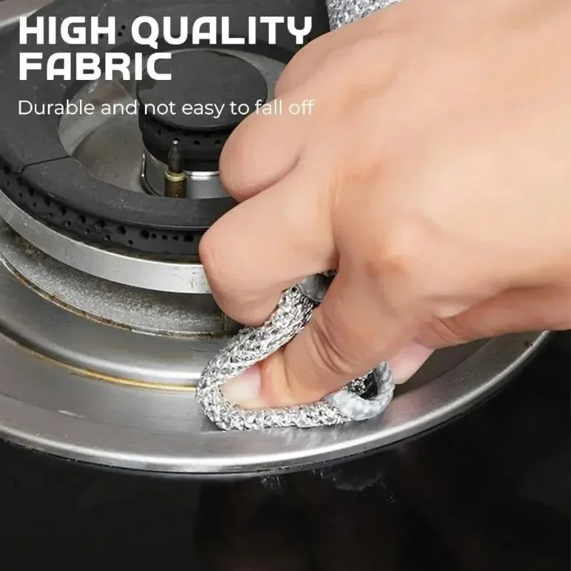 A hand is holding a silver, braided non-stick kitchen cleaning cloth over a metal appliance.