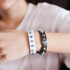 A close-up of a wrist wearing silver metal spike studs for DIY clothing and accessories.