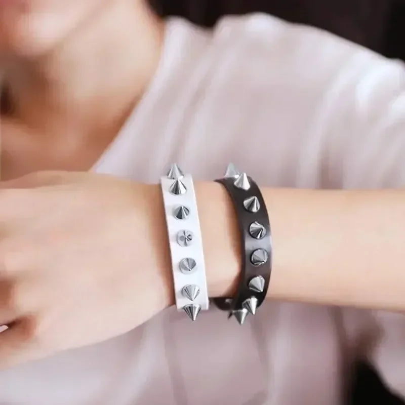 A close-up of a wrist wearing silver metal spike studs for DIY clothing and accessories.