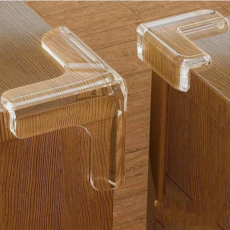 Clear silicone corner edge guards installed on a wooden cabinet for baby safety