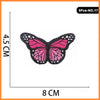 Five embroidered butterfly and rose iron-on patches on a white background.