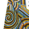 Close-up of a vibrant blue, yellow, and orange African wax print fabric with intricate swirling patterns.