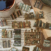 A collection of vintage-style die-cut stickers and small books arranged on a wooden surface.
