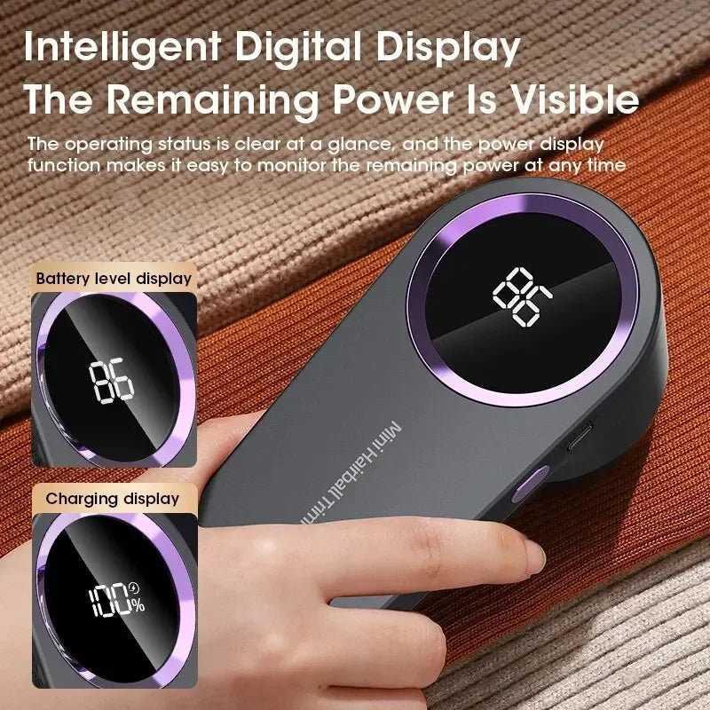 A hand holds a gray electric lint remover with a digital display showing battery level and charging percentage.