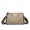 A beige vintage genuine leather women's shoulder bag with stitching and a leather tag.