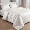 White satin striped jacquard duvet cover set displayed on a bed with sheer curtains.