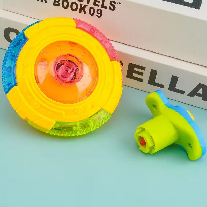 A bright yellow and pink glowing musical spinning top is shown next to its disassembled parts on a light blue surface.