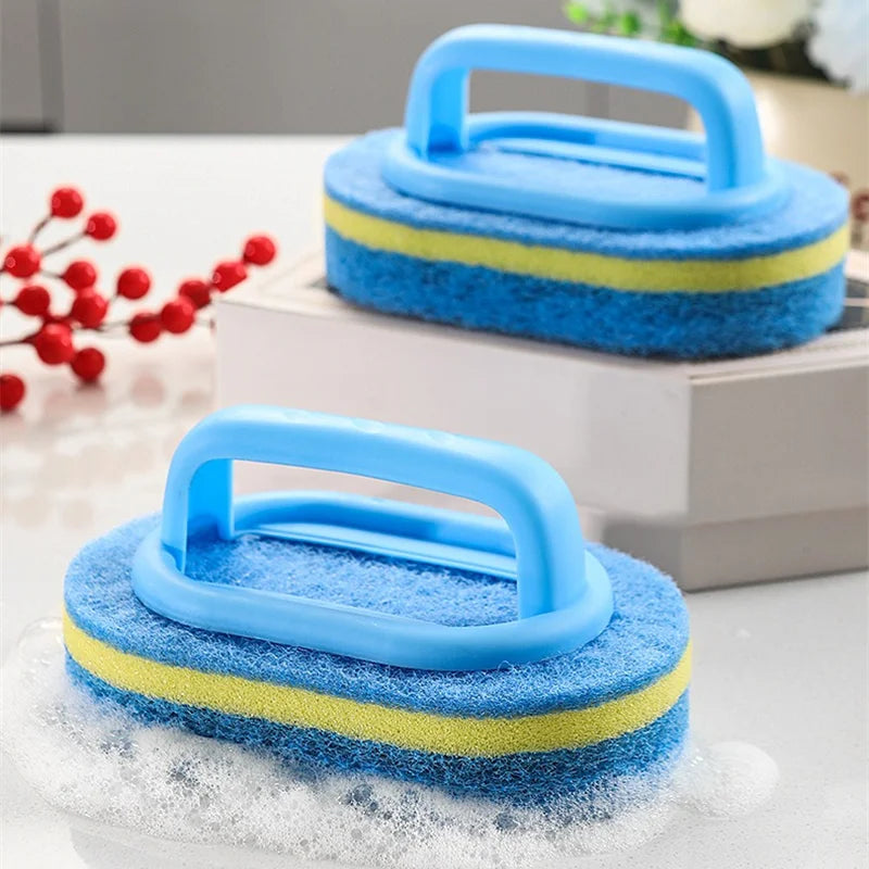 Blue and yellow sponge cleaning brush with a handle resting on a white box.