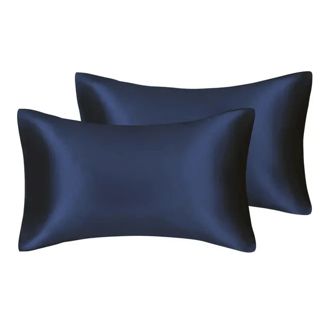 A set of two dark navy blue silky satin pillowcases.