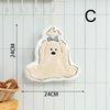 A white cartoon dog shaped hanging hand towel with a blue bow, displayed against a light tiled background.