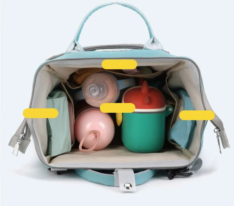A light blue diaper backpack filled with various baby items including bottles and supplies.