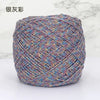 A ball of metallic silk crochet yarn with a multicolored shimmer texture for knitting and macrame.
