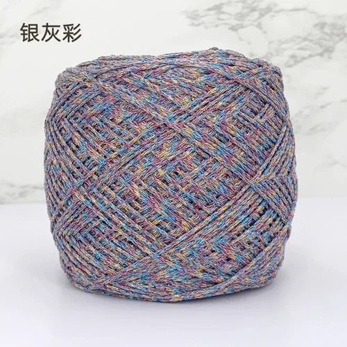 A ball of metallic silk crochet yarn with a multicolored shimmer texture for knitting and macrame.