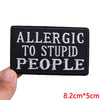 Black embroidered iron-on letter patch with white text that reads Allergic to Stupid People