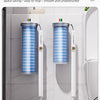 Two wall-mounted holders for a disposable toilet brush kit are displayed on a white tiled wall.