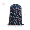 A navy blue drawstring laundry bag with a floral pattern, shown from the front.