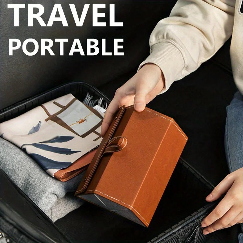 A hand is placing a brown foldable multi-slot sunglasses organizer case into a black travel box.