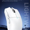 A white lightweight gaming mouse is shown against a dark, rugged background.