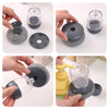A hand demonstrates a press dish brush with a built-in soap dispenser, showing its function and components.