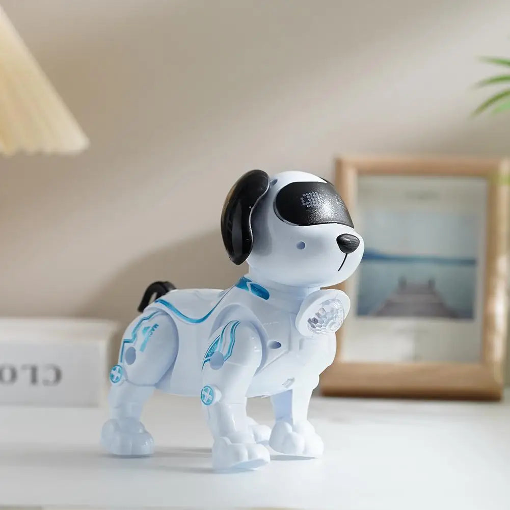 A white interactive robot dog with black ears and blue accents sits on a white surface.